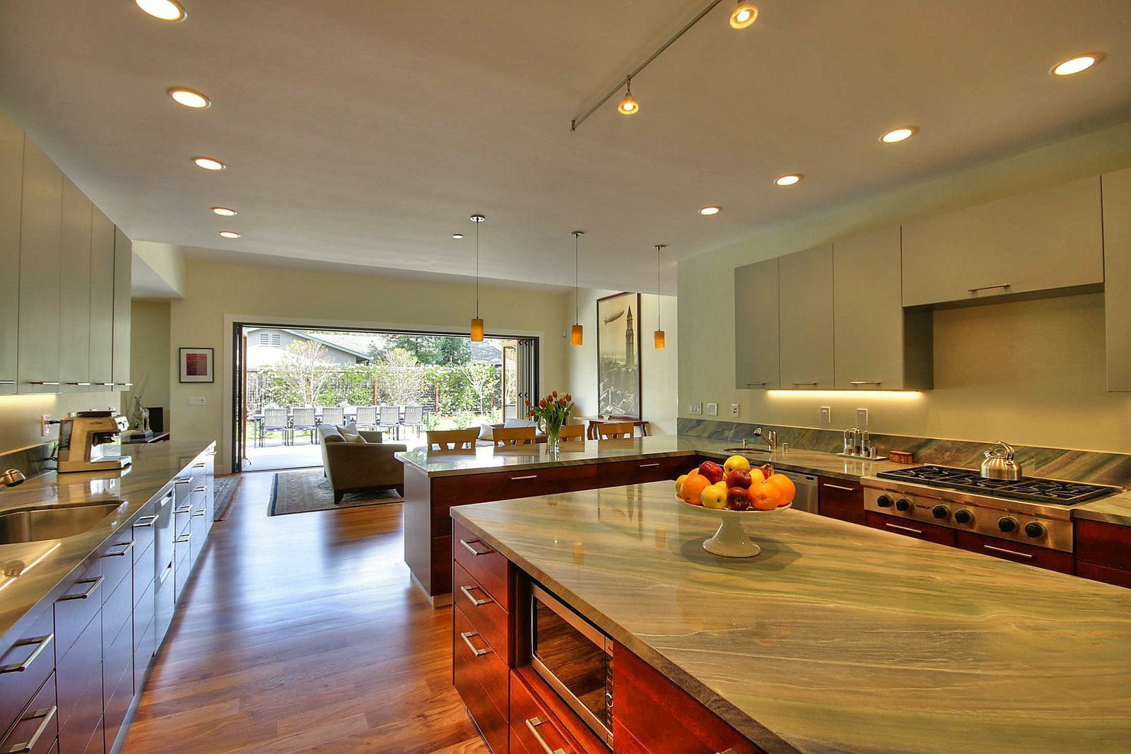 View of kitchen and NanaWall Bifold Doors and Moving Glass Walls opened from the kitchen at new house built in Palo Alto by Lynstar Jack Cannon General Contractor